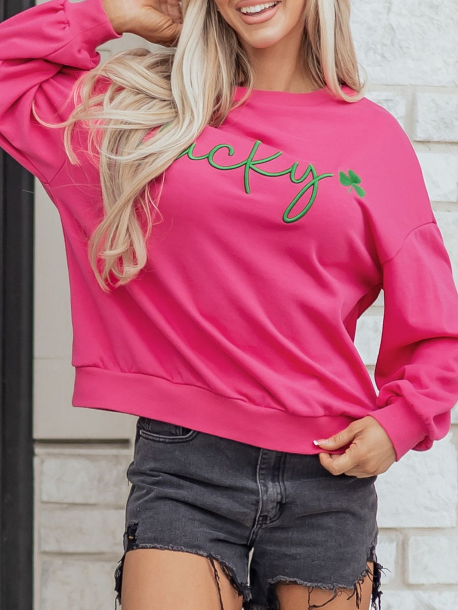 Pink cotton crew neck sweatshirt with green embroidered lucky clover graphic