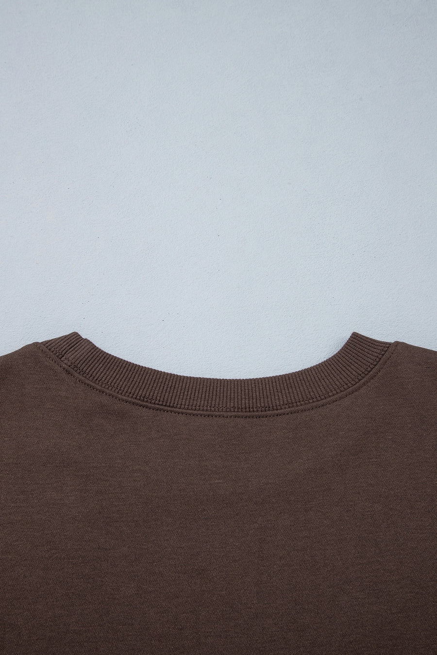dark brown sweatshirt with ribbed cuffs and long sleeve