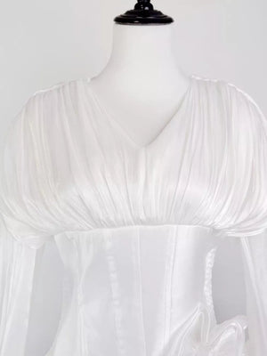 White ruffled mini dress with corset waist and V-neckline