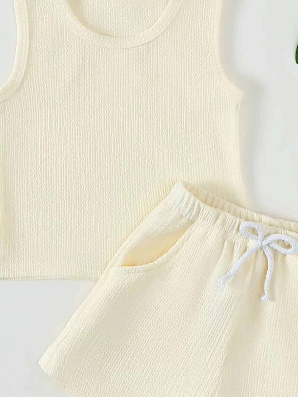 Cream ribbed tank top and shorts set with drawstring waist and pockets.