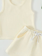 Cream ribbed tank top and shorts set with drawstring waist and pockets.