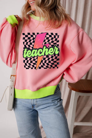 Pink graphic sweatshirt with neon green trim and "Teacher" lightning bolt design.