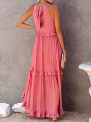 Pink ruffled maxi dress with tie back and tiered skirt.