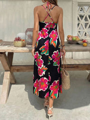 Vibrant floral midi dress with spaghetti straps and crisscross back detail.