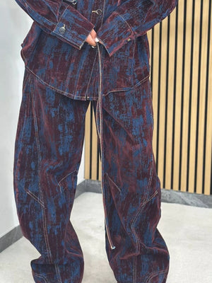 Denim jacket and pants set in burgundy and dark blue with a distressed print and contrast stitching.