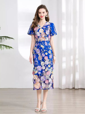 Blue floral embroidered midi dress with V-neck and short puff sleeves.