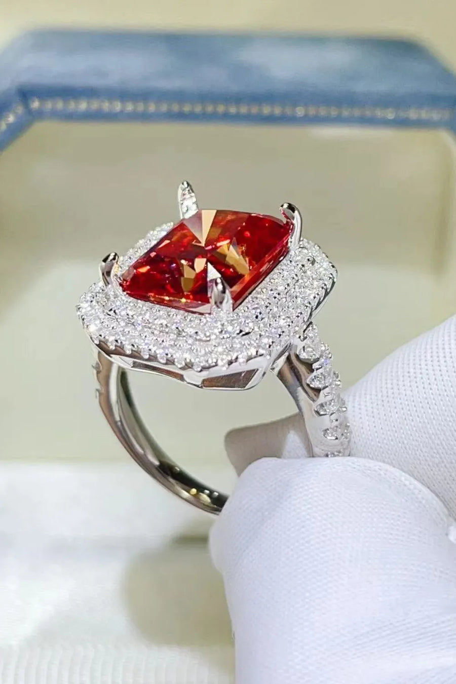 Radiant ruby halo cocktail ring in sterling silver with pave diamond band.