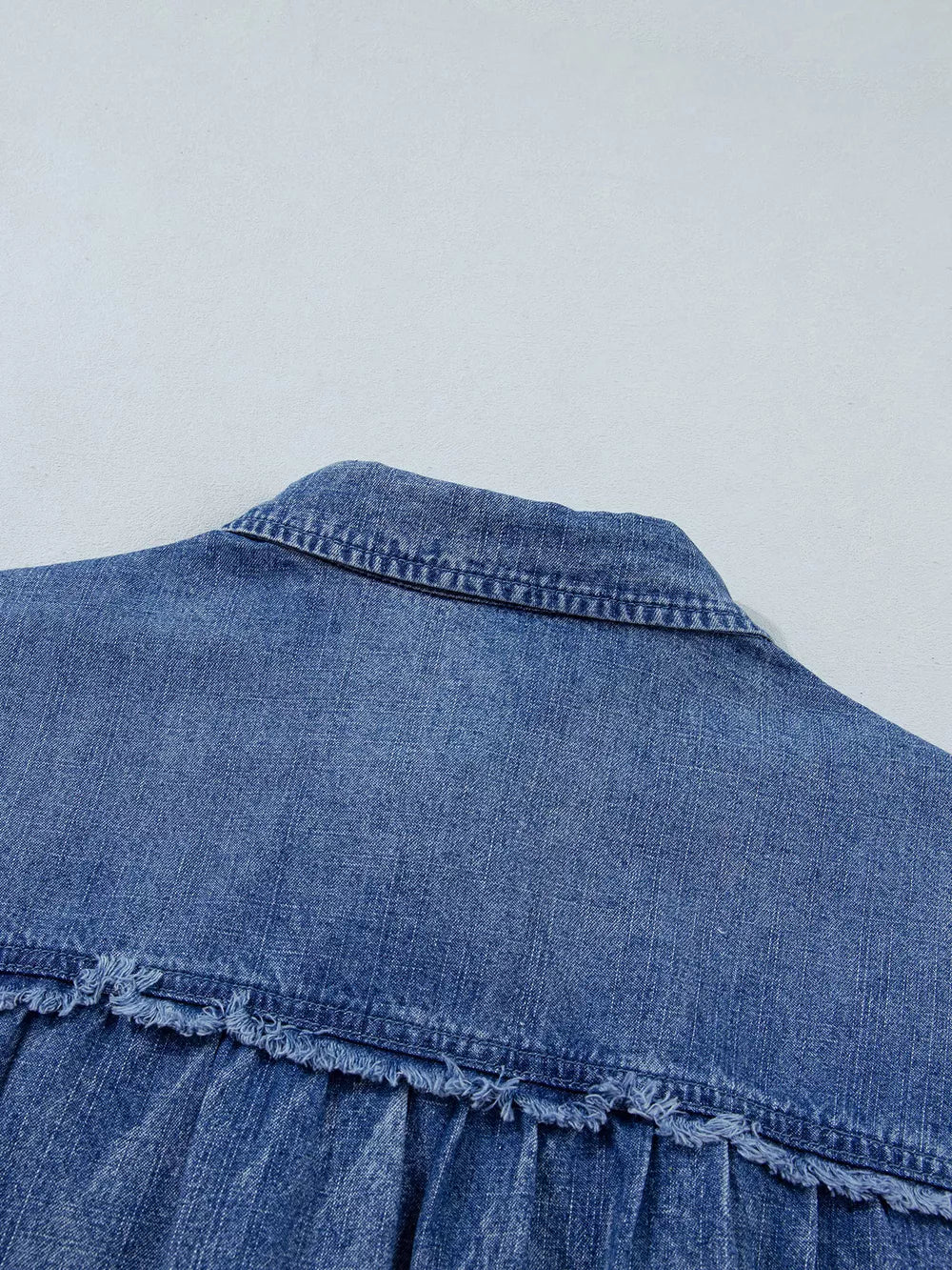 denim blue button-up shirt with button cuffs and 3/4 sleeve