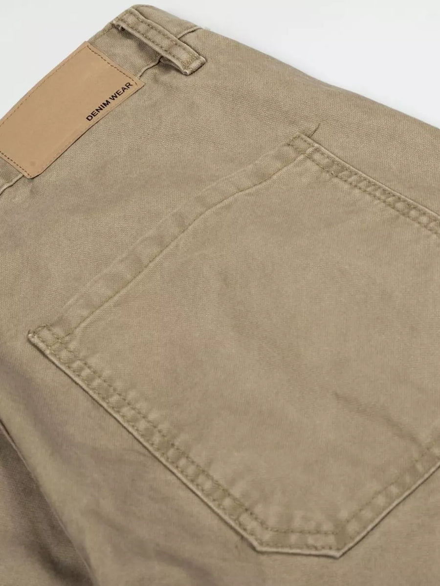 Khaki cargo pants with distressed details and a leather patch reading DENIM WEAR.