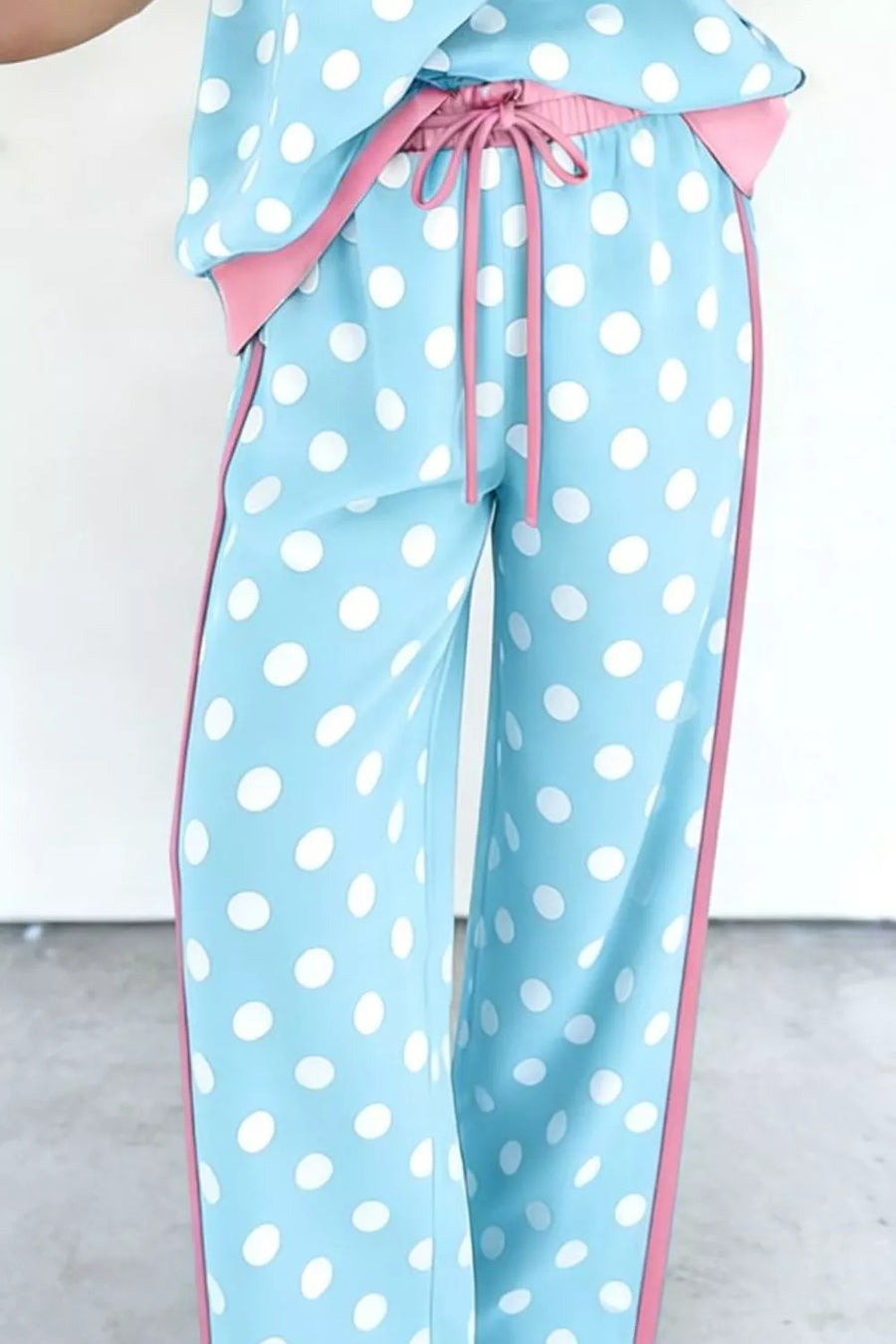 Polka dot pajama pants with pink trim and drawstring waist