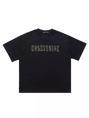 Black oversized cotton t-shirt with textured logo detail on chest