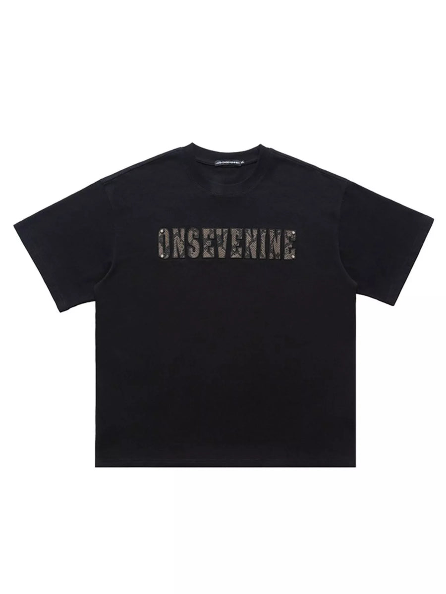 Black oversized cotton t-shirt with textured logo detail on chest
