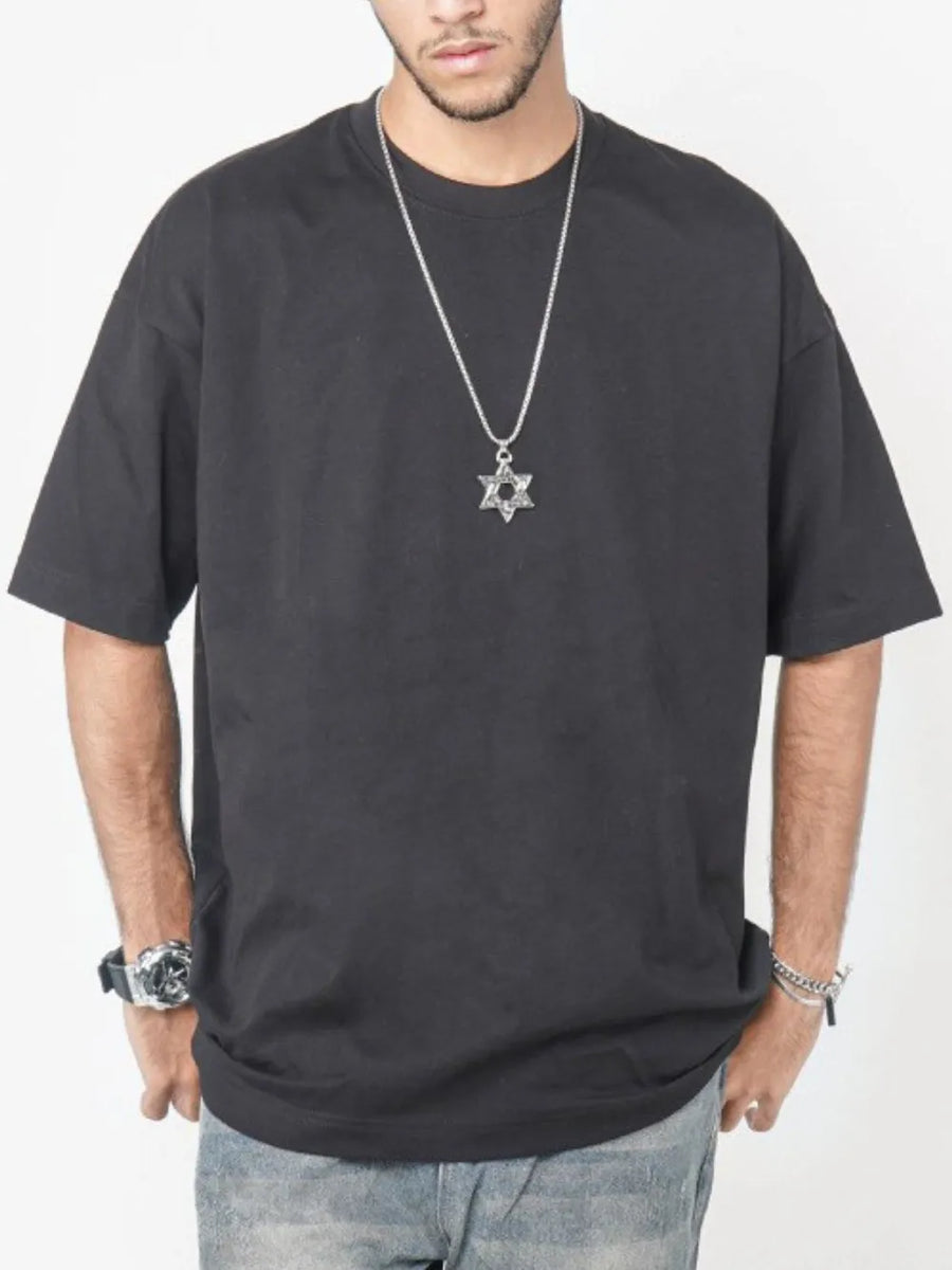 Black oversized crew neck t-shirt with short sleeves and a relaxed fit.