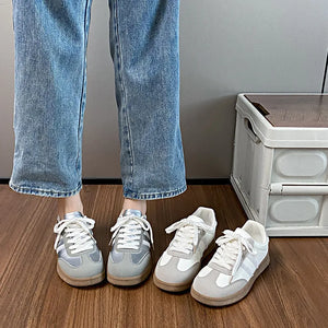 Retro panelled lace-up trainers in beige and silver with white laces and rubber soles.