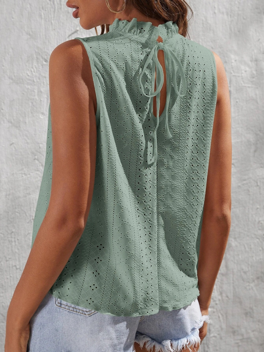 Teal eyelet tank top with ruffled neckline and back tie detail