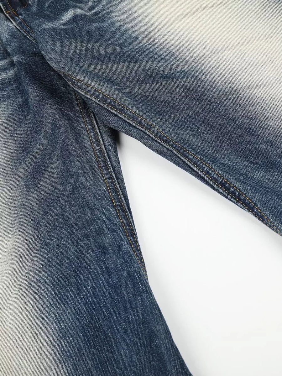 Blue distressed bootcut jeans with faded wash and contrast stitching.