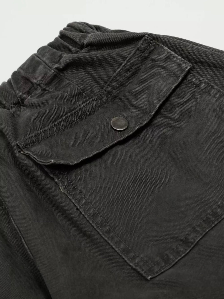 Black cargo pants with elastic waistband and button-flap pocket detail.