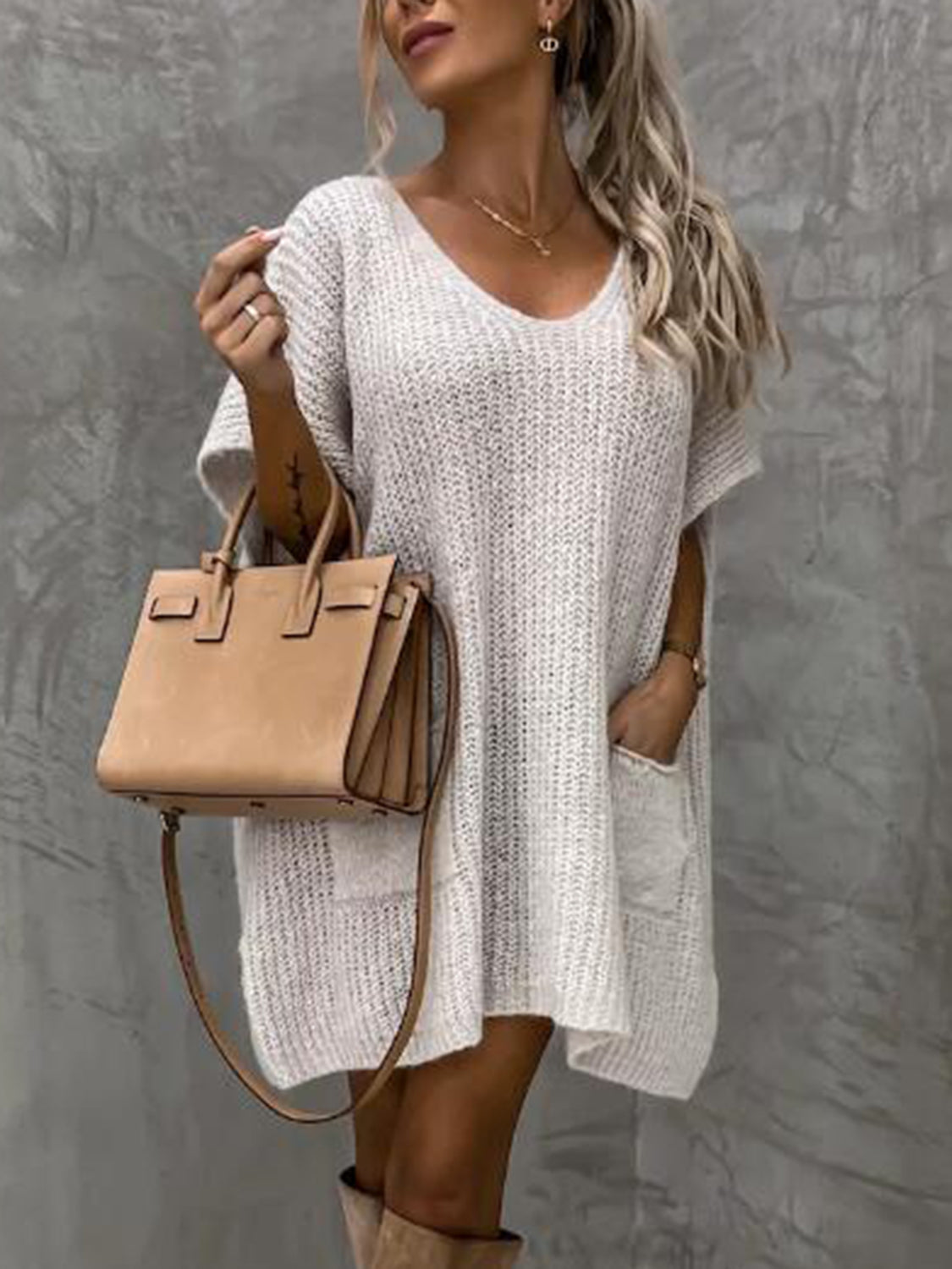 Knit cocoon dress in cream with V-neck, short sleeves, and patch pockets.