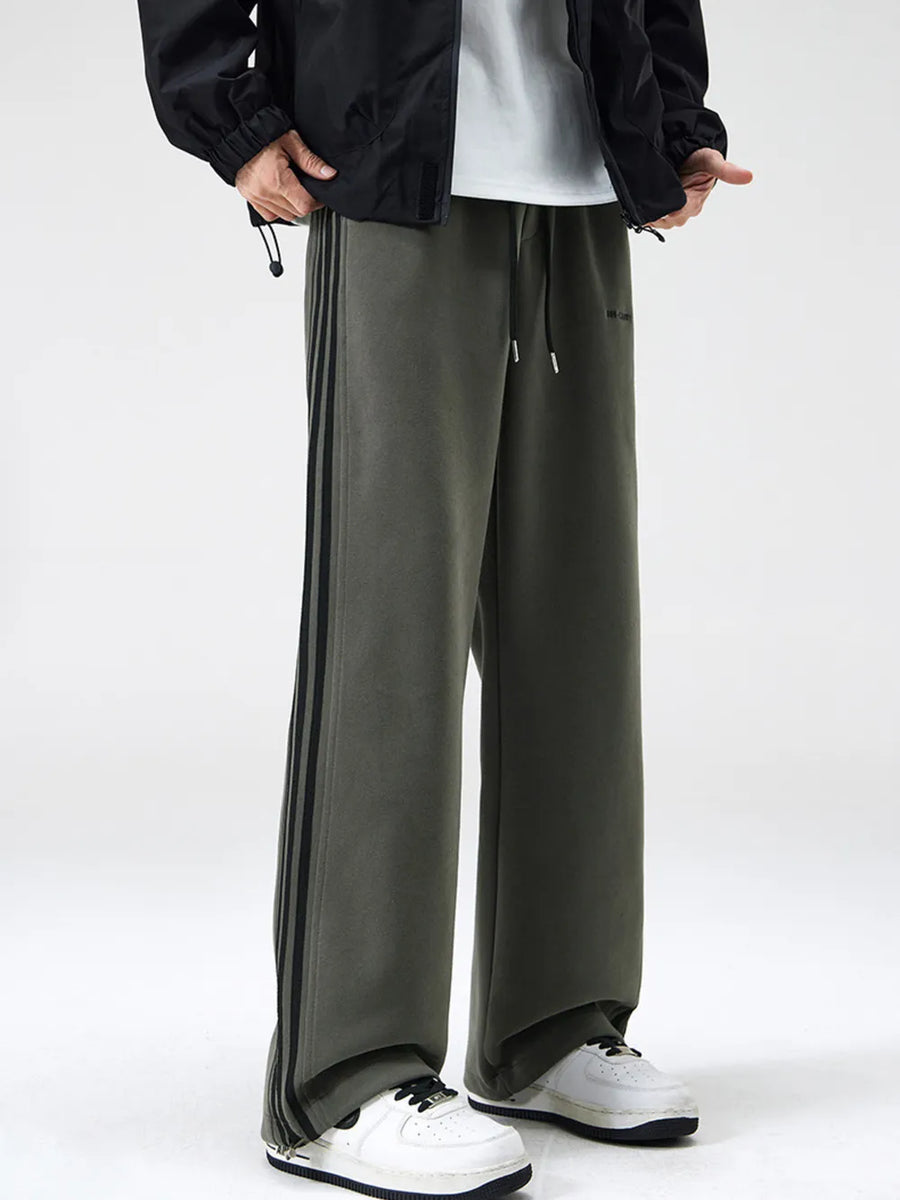 Men's army green sweatpants with black side stripes and drawstring waist