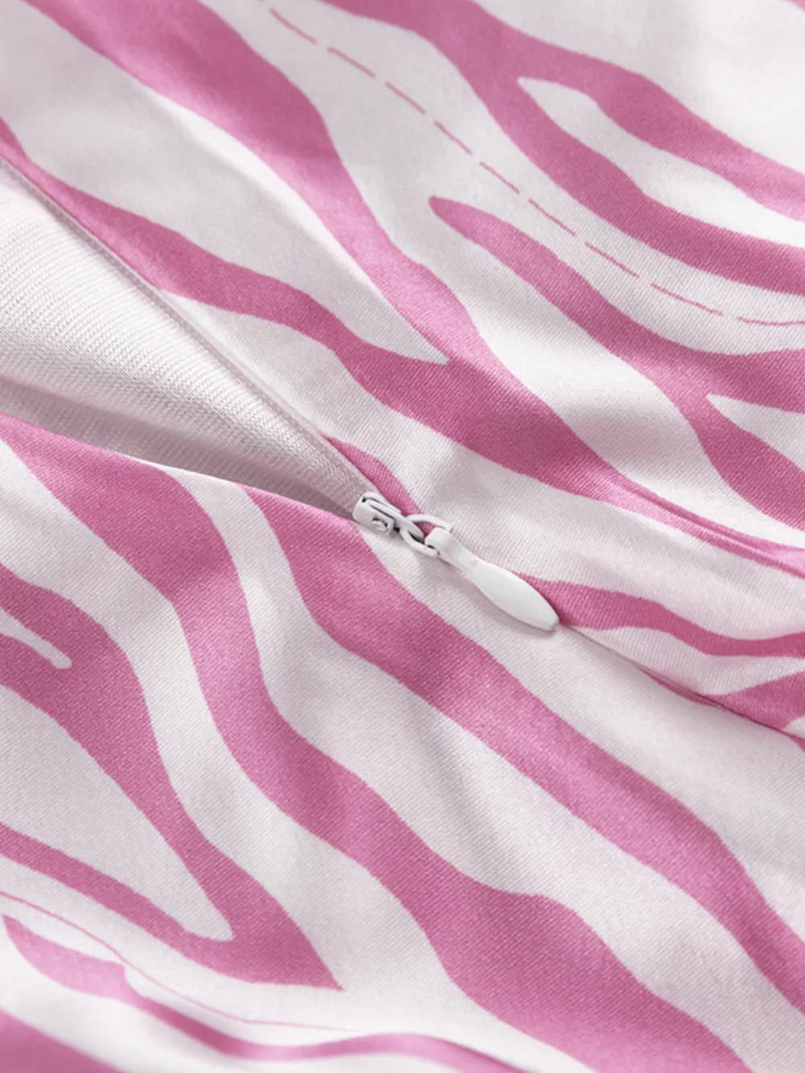 Dress with pink and white zebra print, featuring a zipper closure.