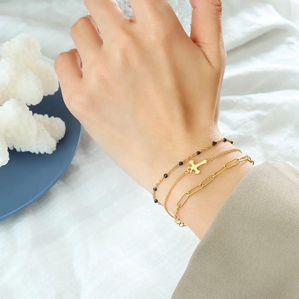 Gold layered chain and bead bracelet trio with cross charm