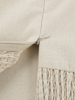 Beige cotton smocked tube dress detail showing zipper and smocked texture.