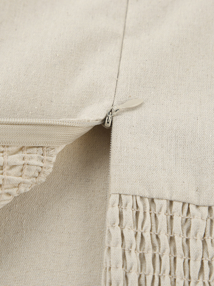 Beige cotton smocked tube dress detail showing zipper and smocked texture.