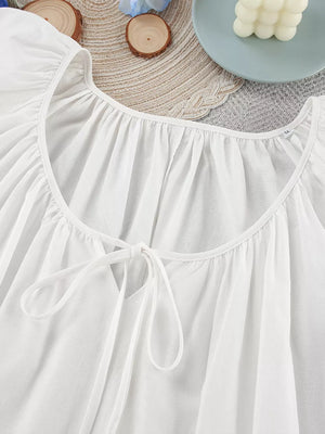ivory mini dress with tie neck and puff sleeve