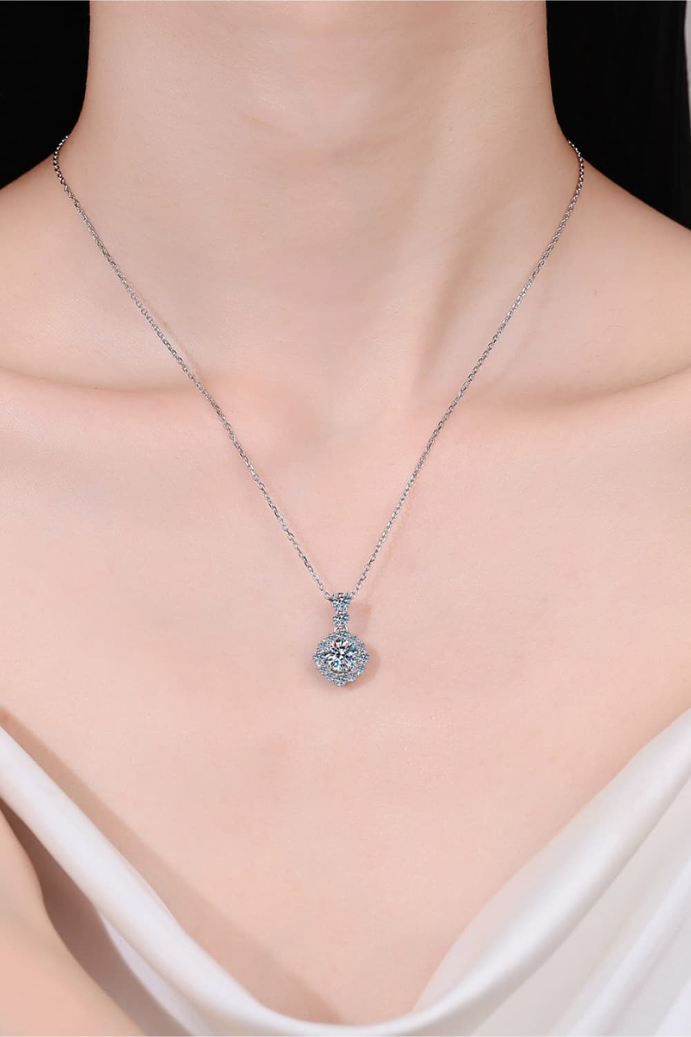 Halo moissanite pendant necklace in sterling silver with a delicate chain.