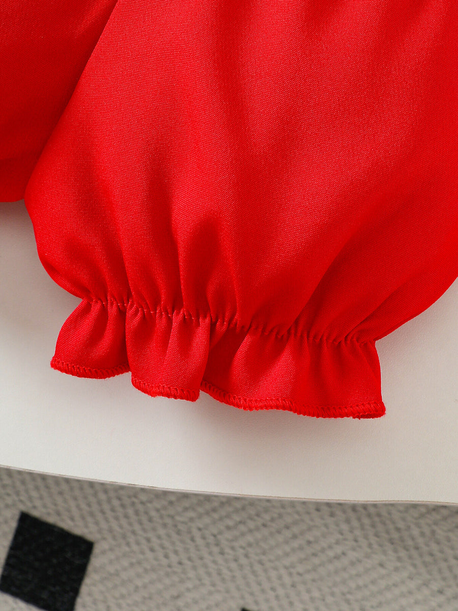 Red baby smocked top detail with ruffled hem