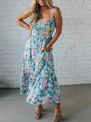 Smocked floral print midi dress with square neckline, spaghetti straps, and tiered hem.