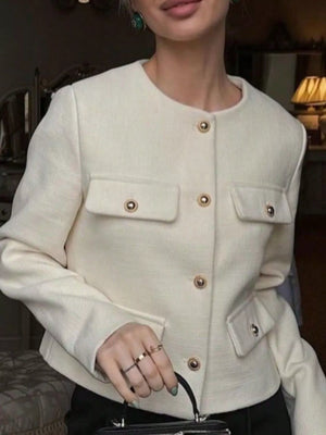 White cropped tweed button-up jacket with gold button details and chest pockets.