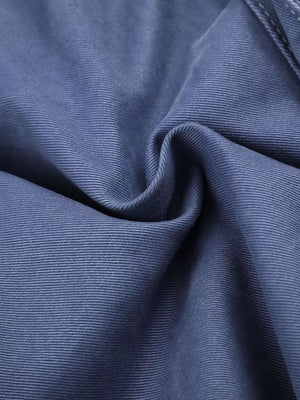 Blue faded cargo capris with distressed detailing and subtle texture.