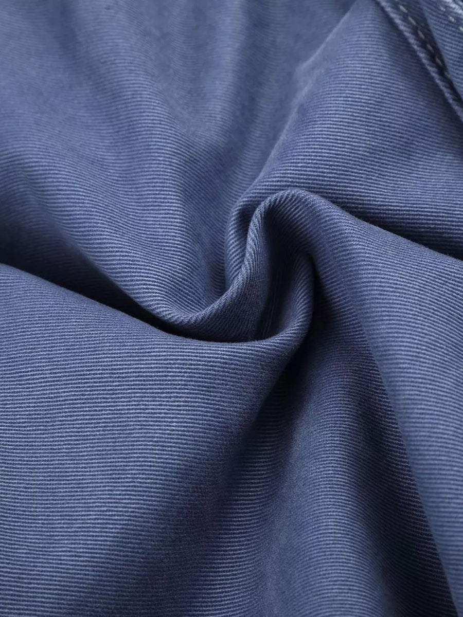 Blue faded cargo capris with distressed detailing and subtle texture.