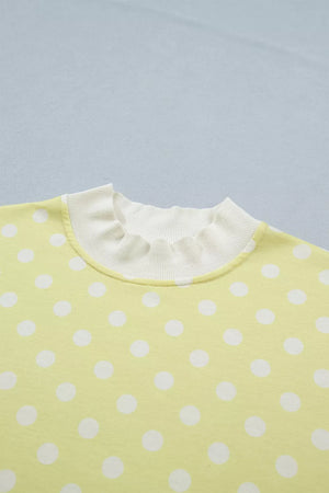 Pastel yellow polka dot top with ruffled neckline detail