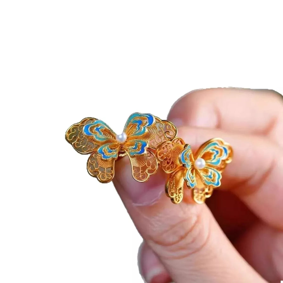 Gold butterfly stud earrings with blue enamel and pearl detail