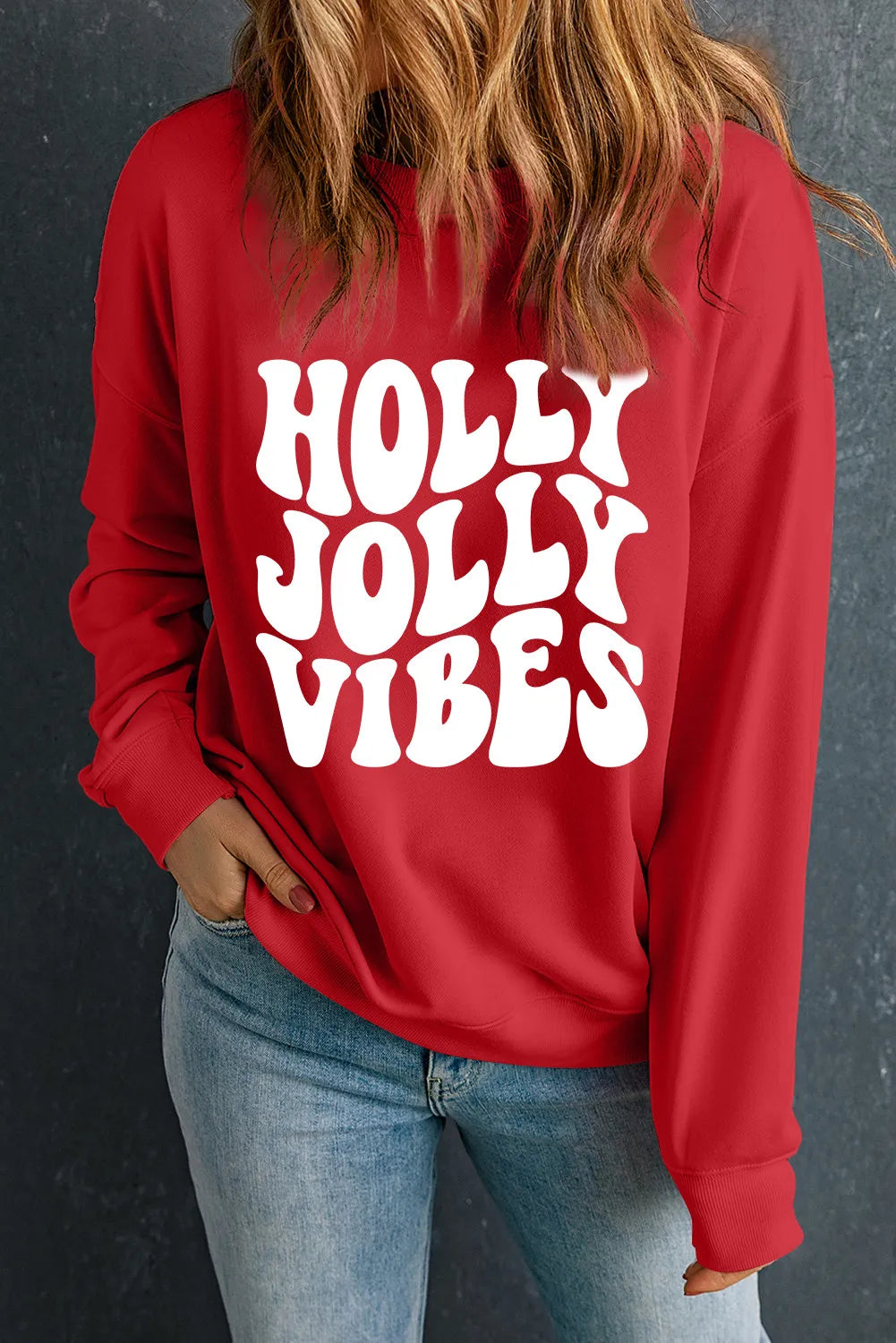 Red crewneck sweatshirt with white "HOLLY JOLLY VIBES" graphic print