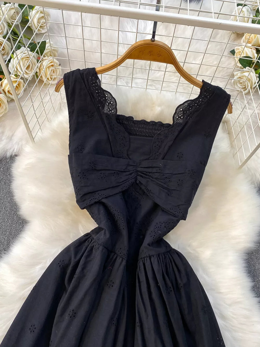 Black eyelet maxi dress with cutout detail, square neckline and ruched bodice.