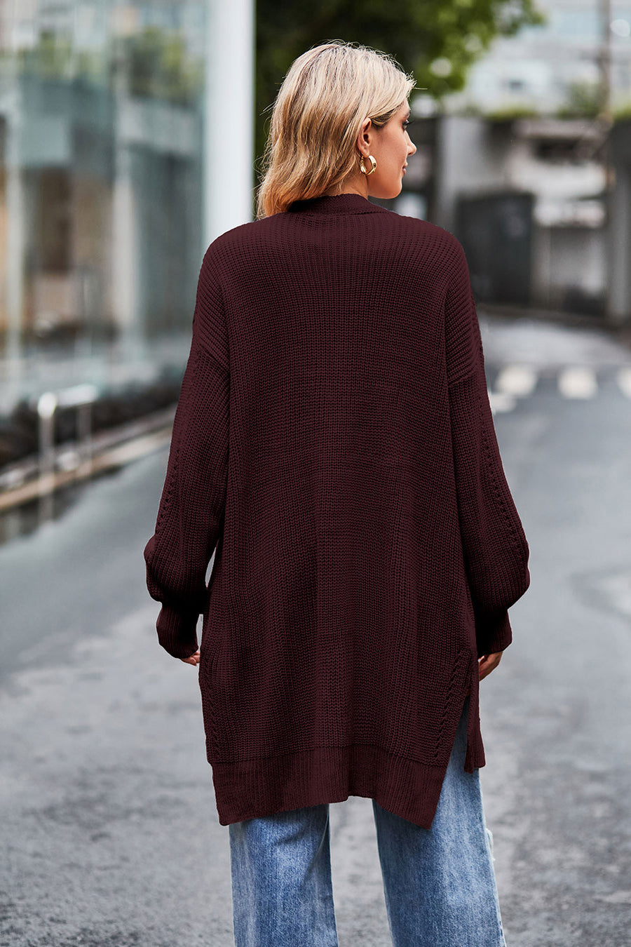Longline open-knit cardigan in wine with side slits and textured sleeves.