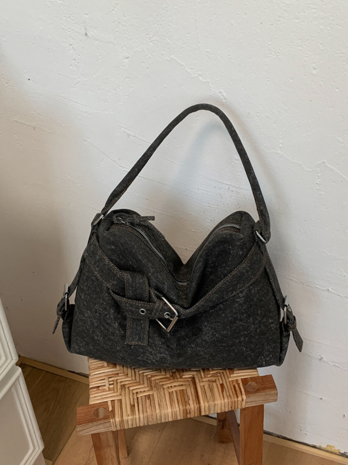 shoulder bag in charcoal featuring buckle details and relaxed fit
