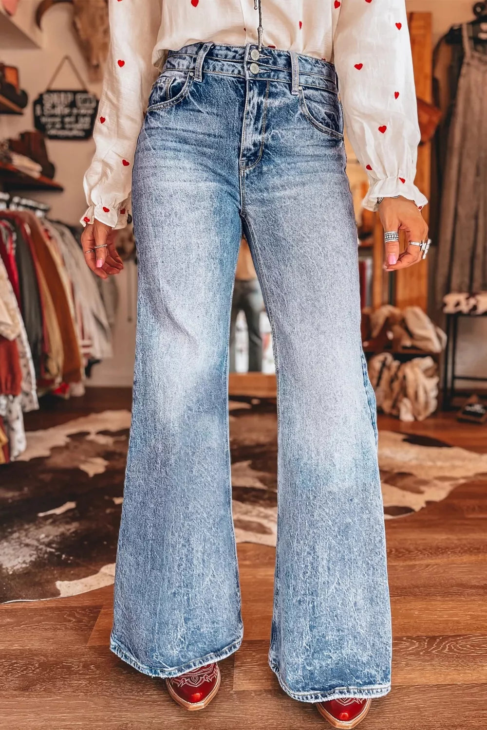 Wide leg jeans in light wash denim with a faded hem.