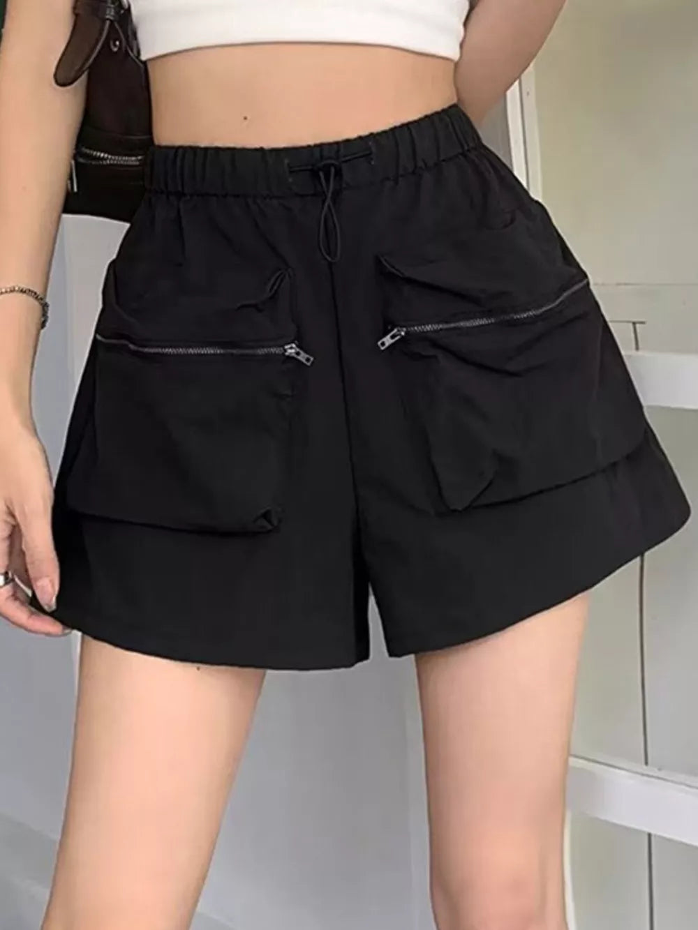 Black cargo shorts with adjustable drawstring and zippered pockets