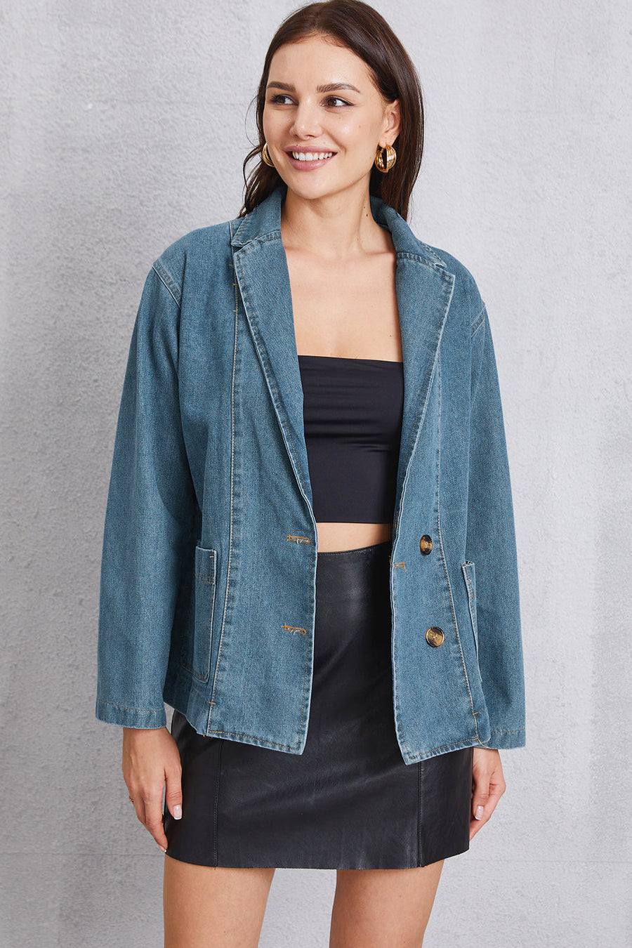 Medium wash denim blazer with tailored seam detailing and button front.