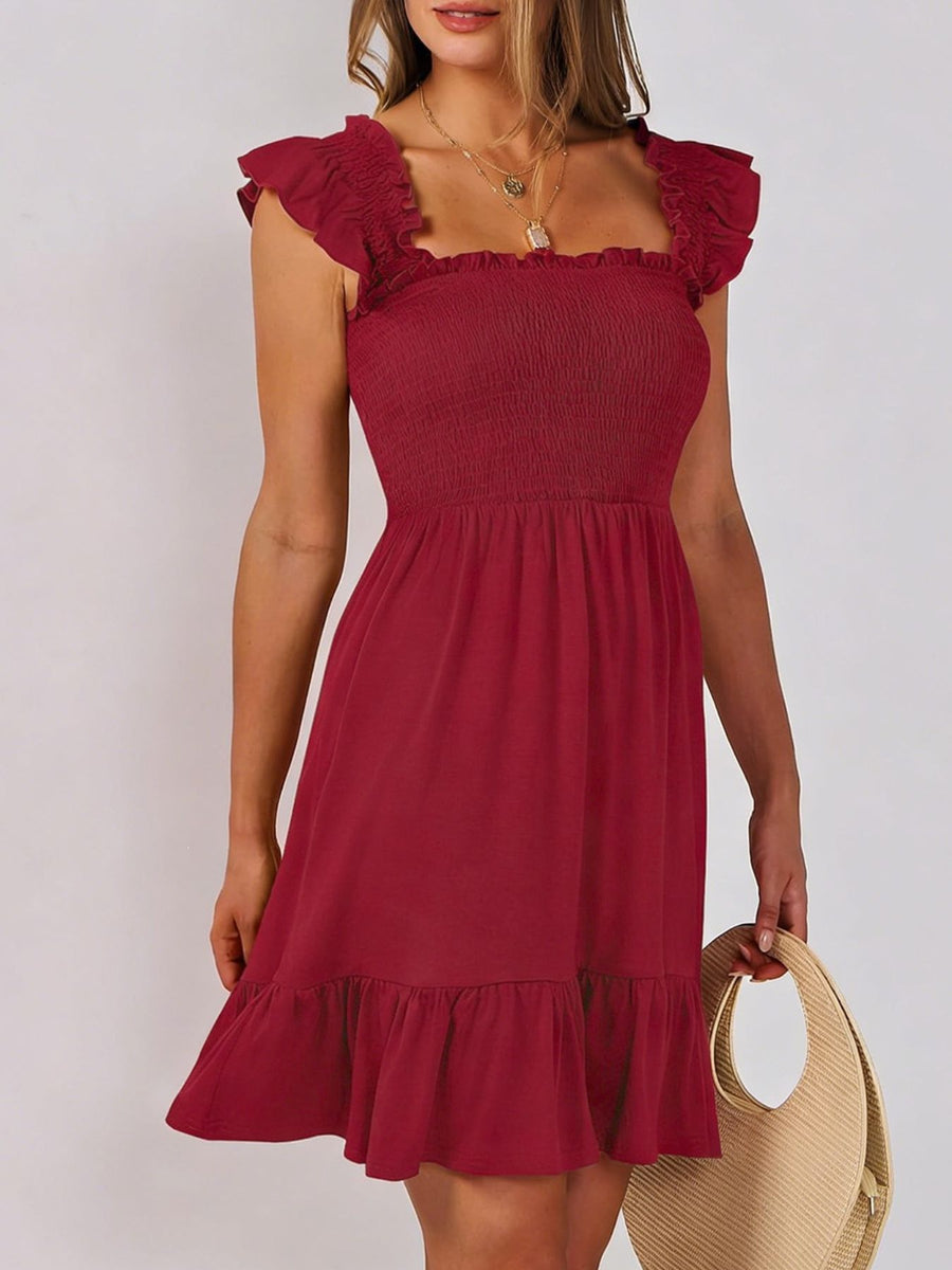 Burgundy smocked mini dress with square neckline and ruffle hem.