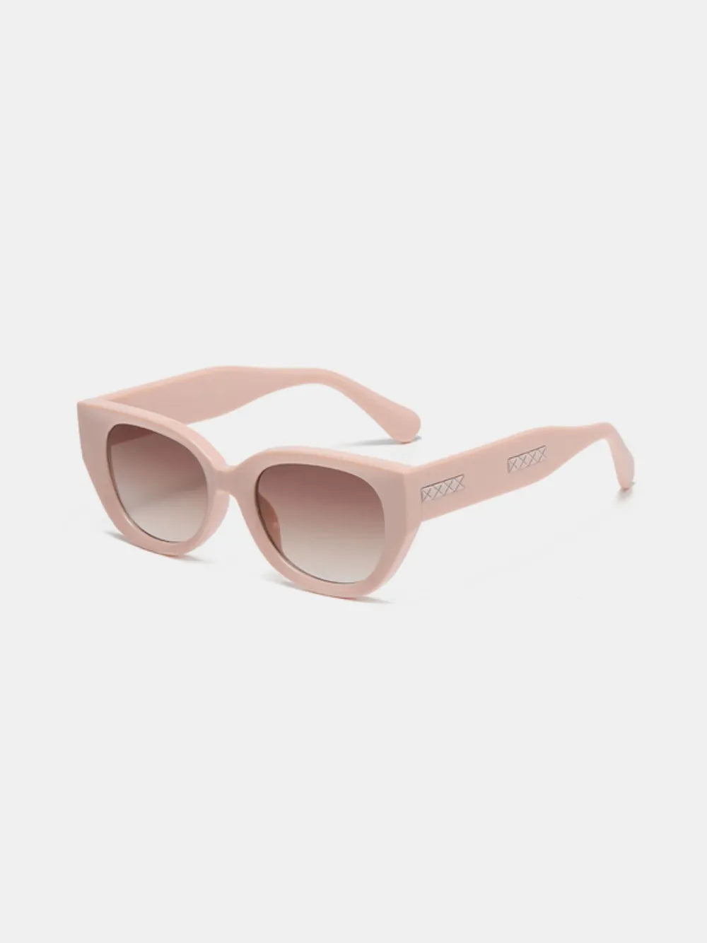 Blush pink sculpted cat eye sunglasses with gradient lenses and decorative detail on the temples.