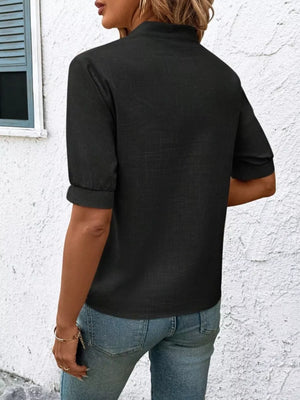 Black embroidered notched blouse with cuffed sleeves and a relaxed fit.