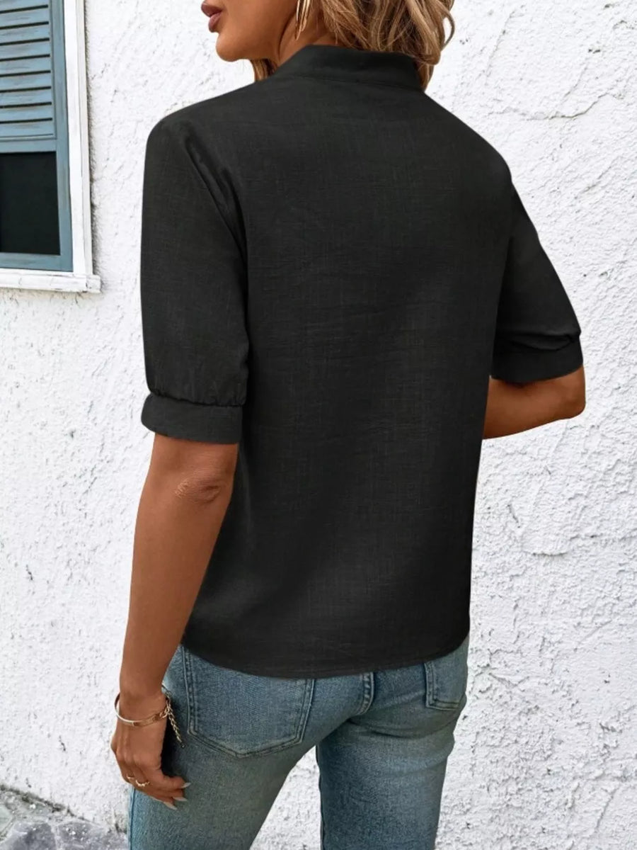Black embroidered notched blouse with cuffed sleeves and a relaxed fit.