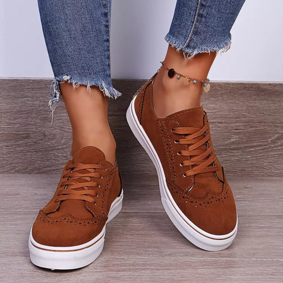 Brown matte finish lace-up sneakers with brogue detailing and white soles.