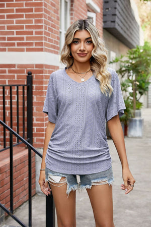 Perforated dolman sleeve blouse with V-neck and side ruching in light purple.
