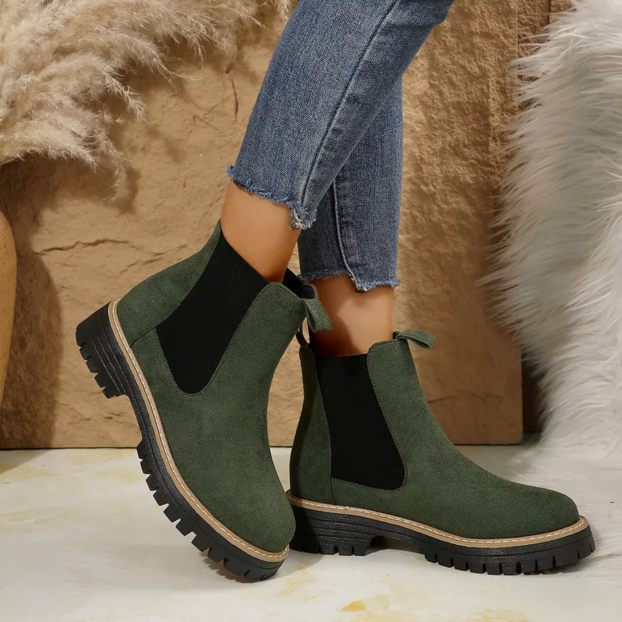 Green suede chelsea ankle boots with chunky sole and elastic side panels.